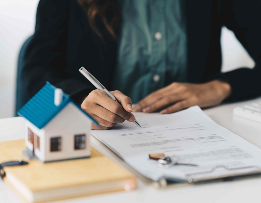 Close up Business woman or Real Estate agent explain signing agreement for buying house. Bank manager and real estate concept