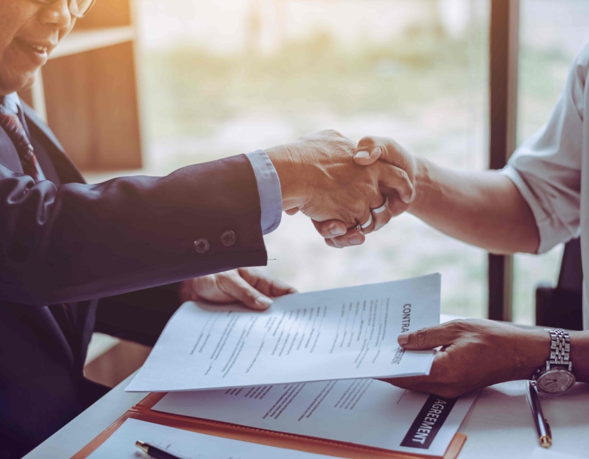 Middle age partner lawyers attorneys shaking hands after discussing a contract agreement done, Asian people.